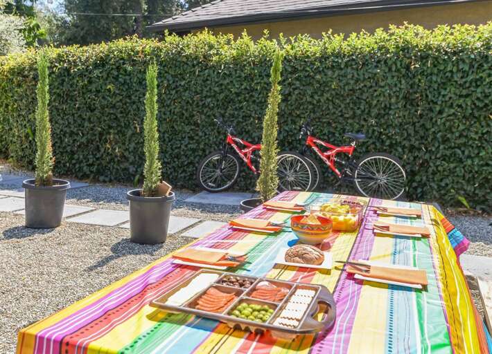 Experience vibrant outdoor dining with a Mexican-themed table cover and festive banner provided by your host—perfect for a memorable meal under the stars. Experience vibrant outdoor dining with a Mexican-themed table cover and festive banner provided by your host—perfect for a memorable meal under the stars.